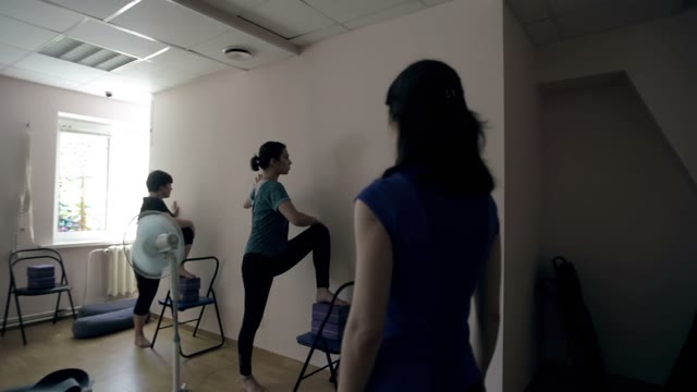 Group Of Students Performs An Exercise In Yoga