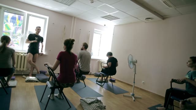 The Trainer Of Yoga Leads A Lecture In Front Of Students