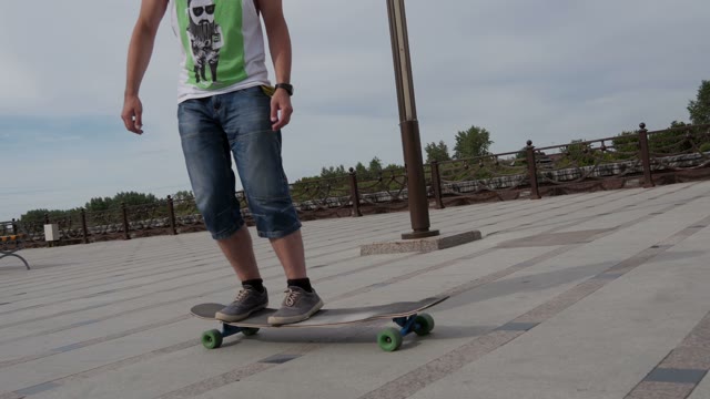 Young Guy Riding A Longboard And Doing Tricks