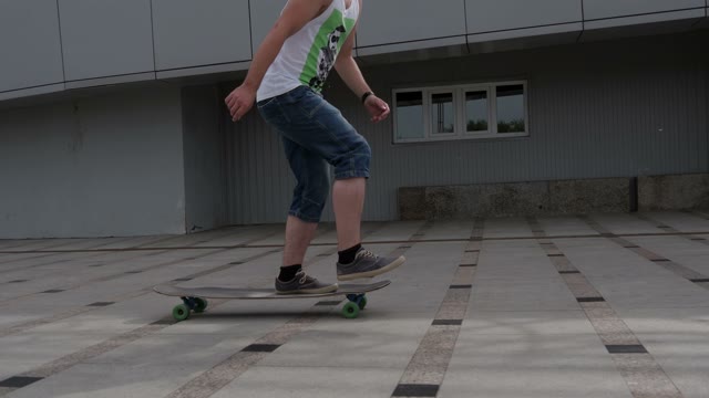 A Young Man In Shorts Accelerated On Longboard