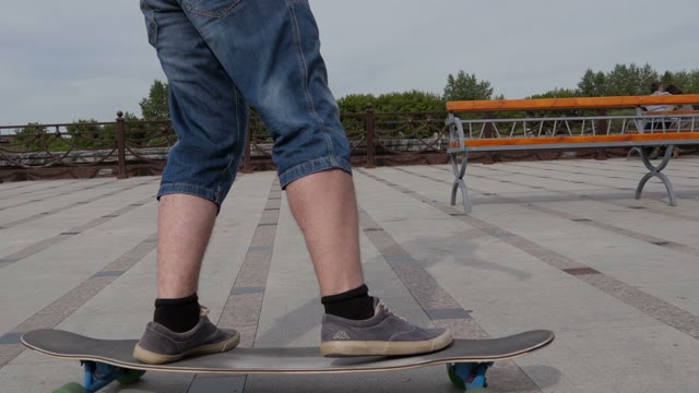 A Young Man Riding A Longboard