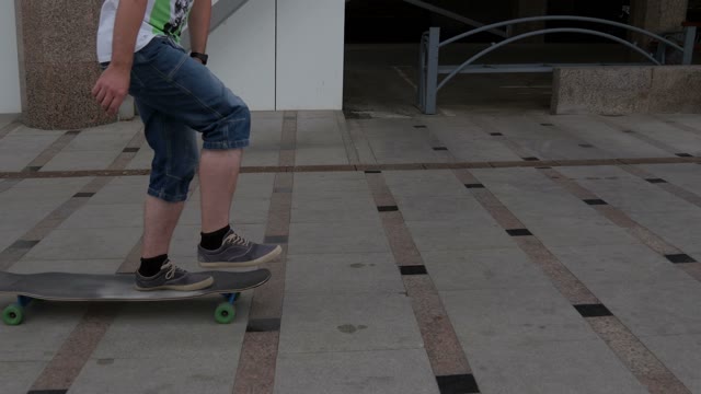 A Young Man Riding A Longboard