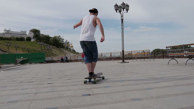A Young Man Riding A Longboard