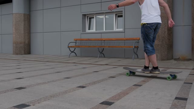 A Young Man Riding A Longboard