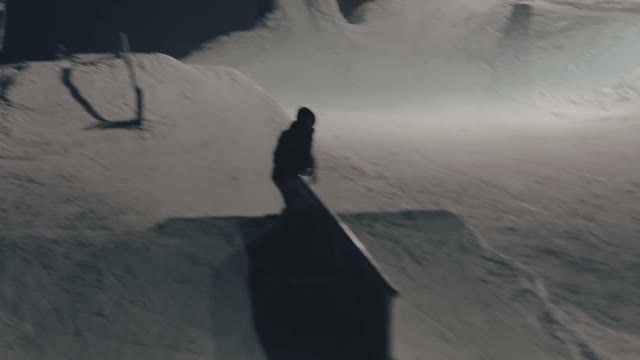 Snowboarder Doing Trick On The Rail