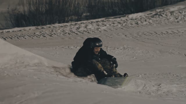 Snowboarder Has A Rest On The Slope