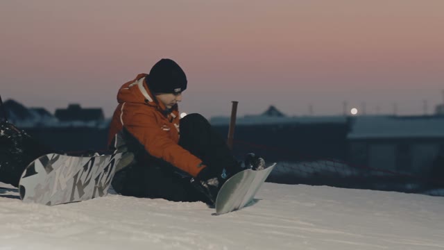 Snowboarder Has A Rest On The Slope