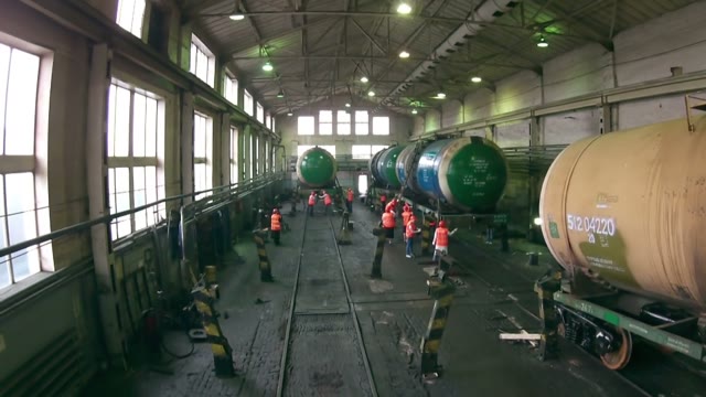Workers Wash Tank In The Hangar