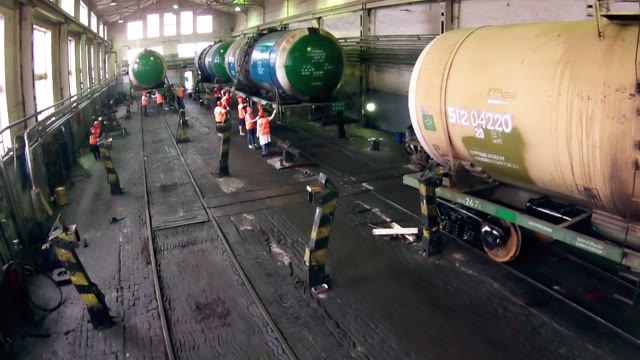Women Workers Wash Tank In The Hangar