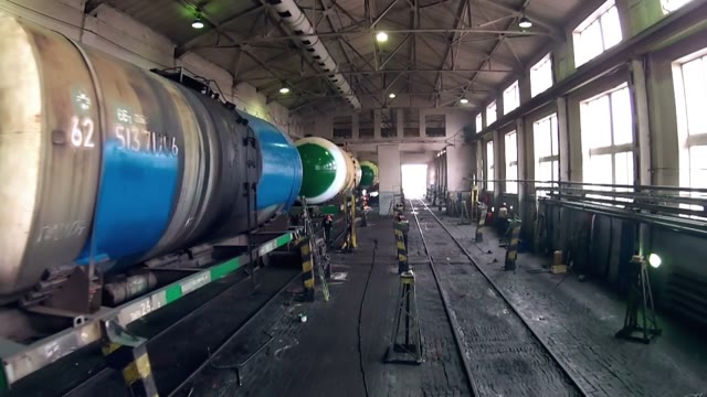 Workers Repairing The Tank Car In Hangar