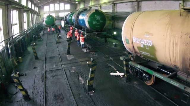 Workers Wash And Clean The Train In The Hangar