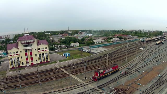Red Locomotive Passing The Station On The Background