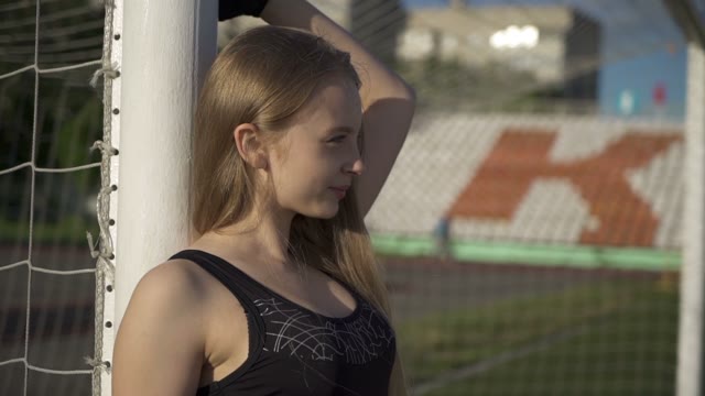 Young Female Athlete Standing Near Of A Soccer Gate