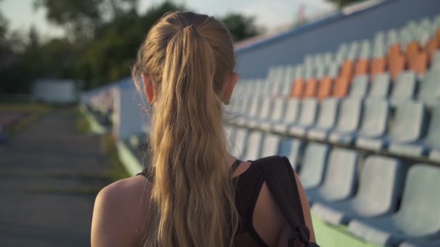 Young Woman Athlete Goes Through The Stadium