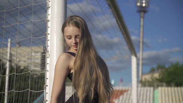 Young Female Athlete Standing Near Of A Soccer Gate