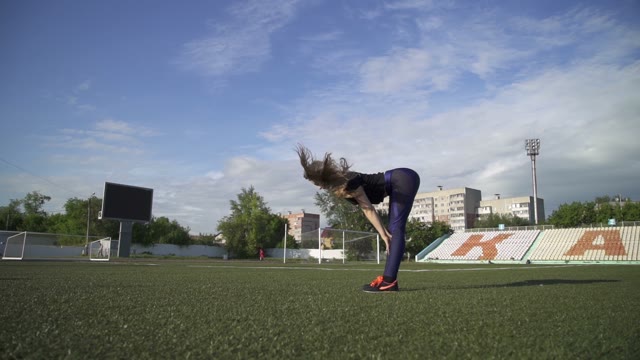 Young Athlete Woman Warming Up In The Stadium