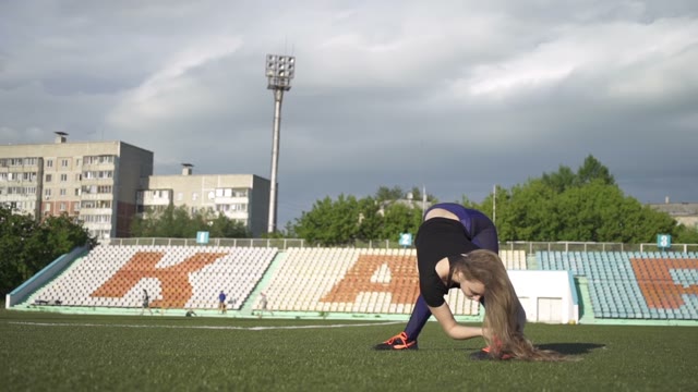 Young Athlete Woman Warming Up In The Stadium