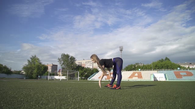 Young Athlete Woman Warming Up In The Stadium