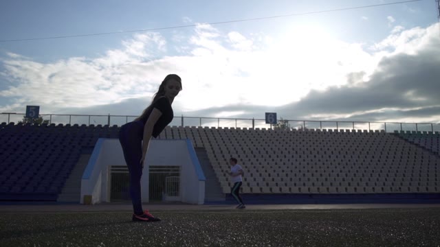 Young Athlete Woman Warming Up In The Stadium