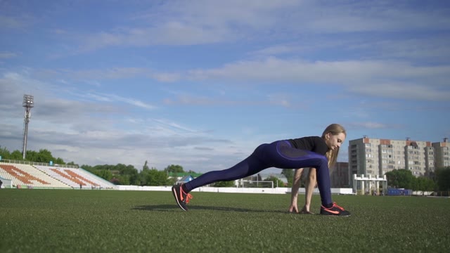 Young Female Athlete Doing Stretching And Sits On Twine