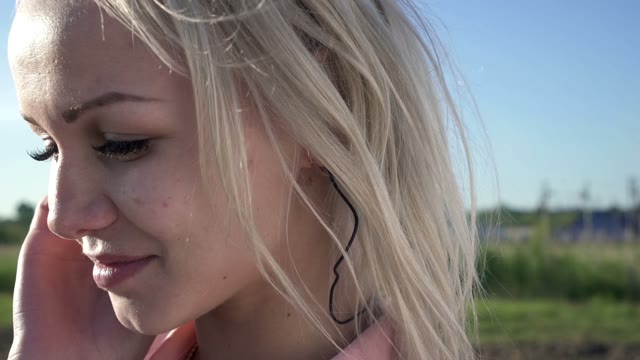 Beautiful Blonde In Headphones Posing In Front Of Camera