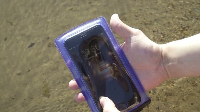 Smartphone In A Waterproof Pouch Lay Down In The Water