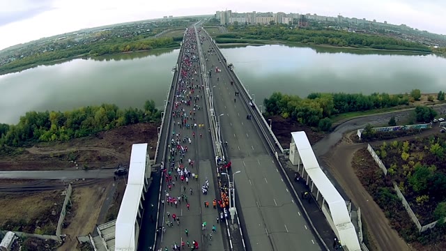 People Run A Marathon On The Road Bridge