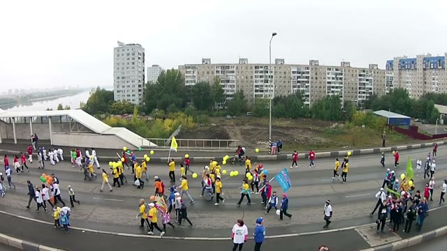 Young People Run A Marathon On The Road Bridge Across The River