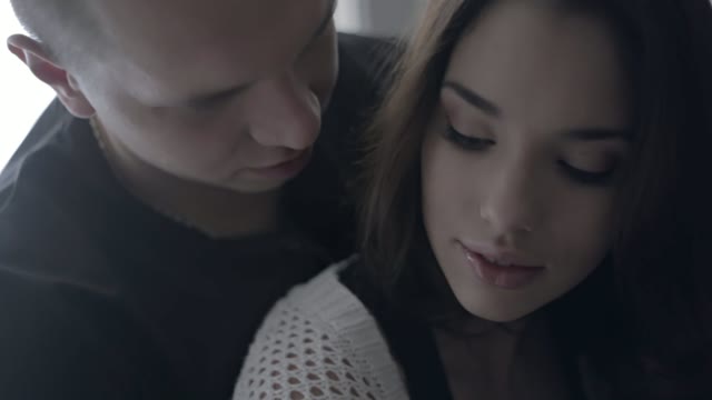 Young Man Hugs A Beautiful Girl From Behind