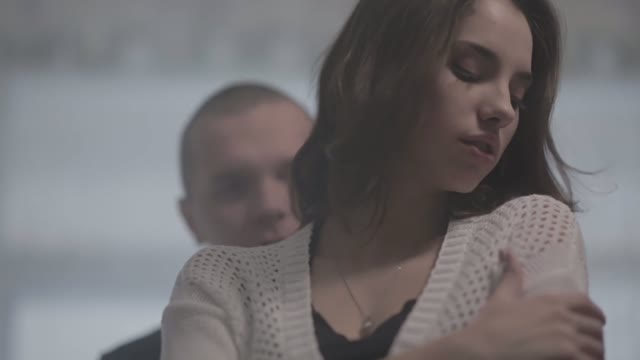 Young Man Hugs A Girl From Behind