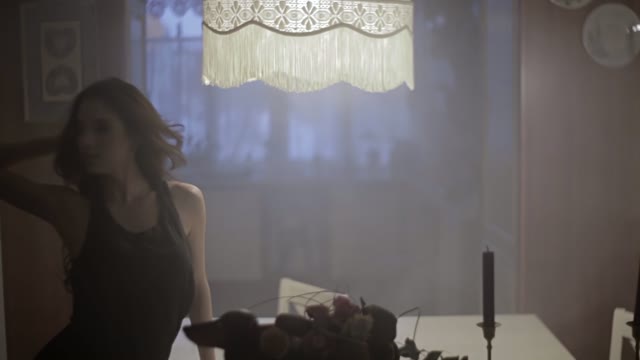 Young Woman Dancing In The Kitchen In The Spotlight
