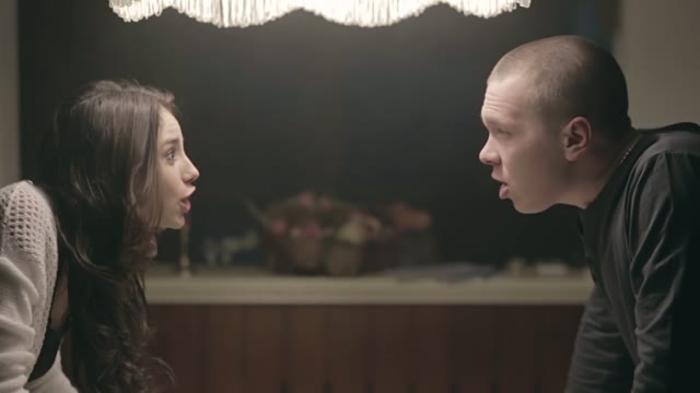 Family Quarrel. A Man And A Woman Shouting At Each Other In The Kitchen