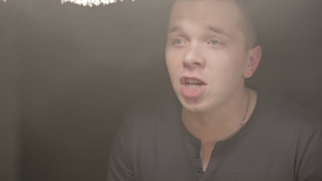 Young Man Emotionally Shouts And Gesticulates. Glass Of Water In The Face