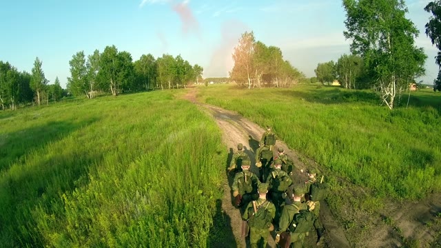 Many Soldiers Running Along The Forest Path