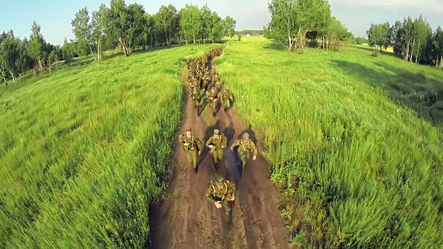Soldiers Run On The Road In A Field