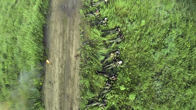 Soldiers Wearing Gas Masks Lying In The Grass
