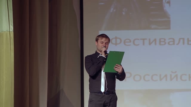 The Young Man With Plate Reads The Text On The Stage