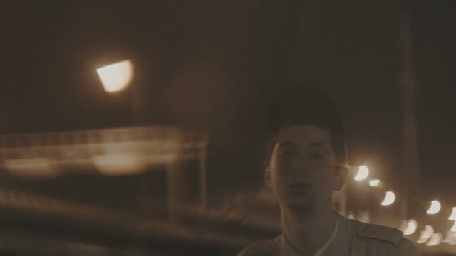 The Young White Guy Rapping On The Street At Night Near The Bridge