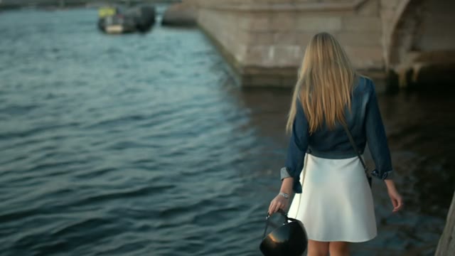 A Pretty Young Girl Walking Along The Promenade