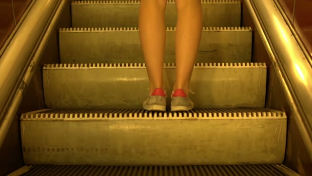 Cute Girl Is Moving Up On The Escalator