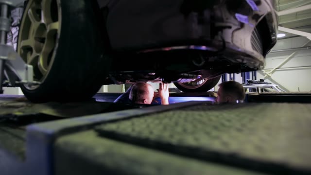 Mechanics Inspect The Machine Driveshaft