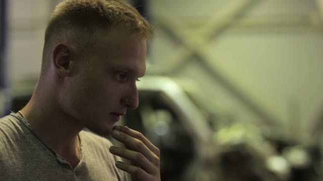 Young Man Looking At The Computer Reading Condition His Car