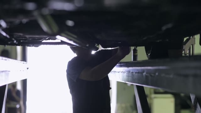 Worker Repairs Car
