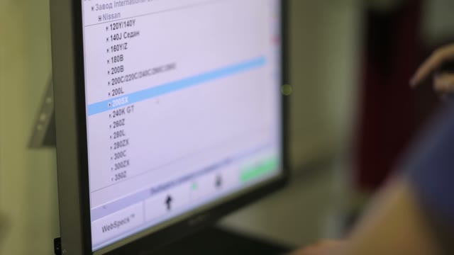 Worker Selects The Desired Options Repair Machine On The Computer