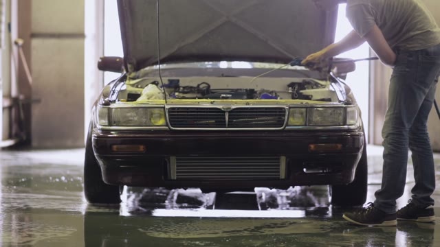Young Worker Dries Engine