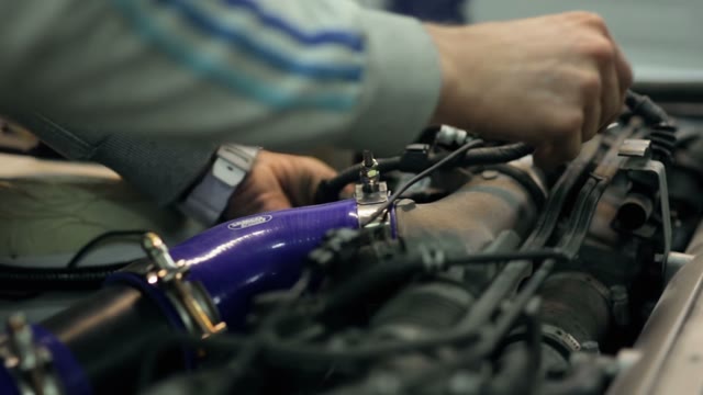 Mechanic Customizes The Engine In The Car