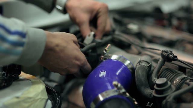 Mechanic Customizes The Engine In The Car
