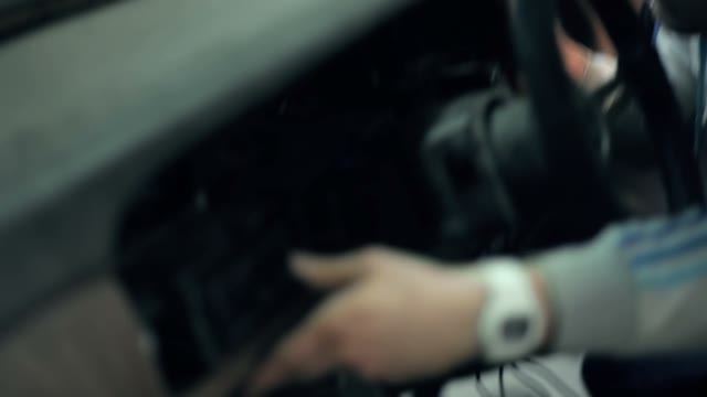 Mechanic Installs In Car Dashboard