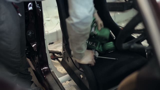 Mechanic Installs A Sports Seat In The Car