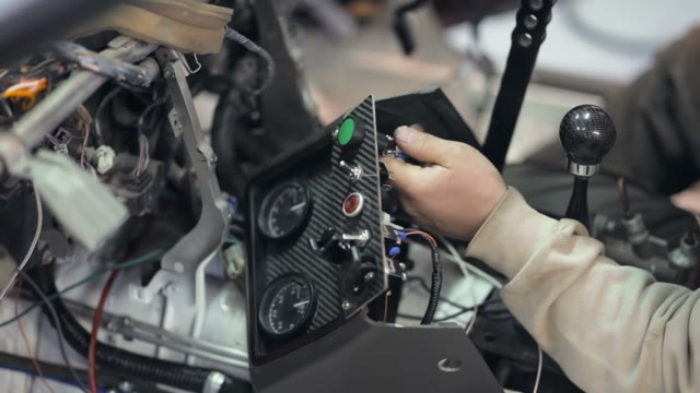 Mechanic Installs Additional Dashboard